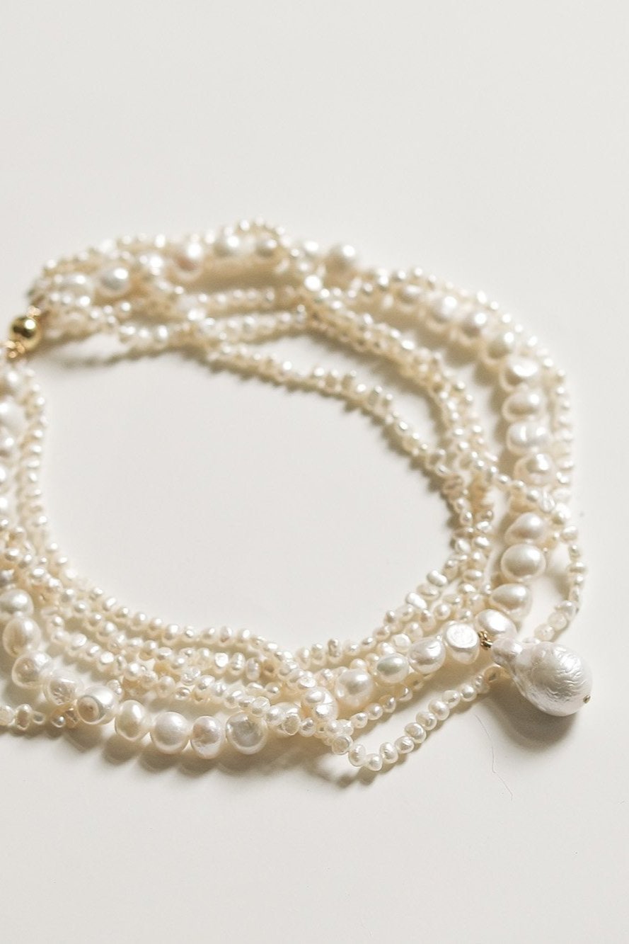 Flat image of layered freshwater pearl necklace with keshi pearls on white background