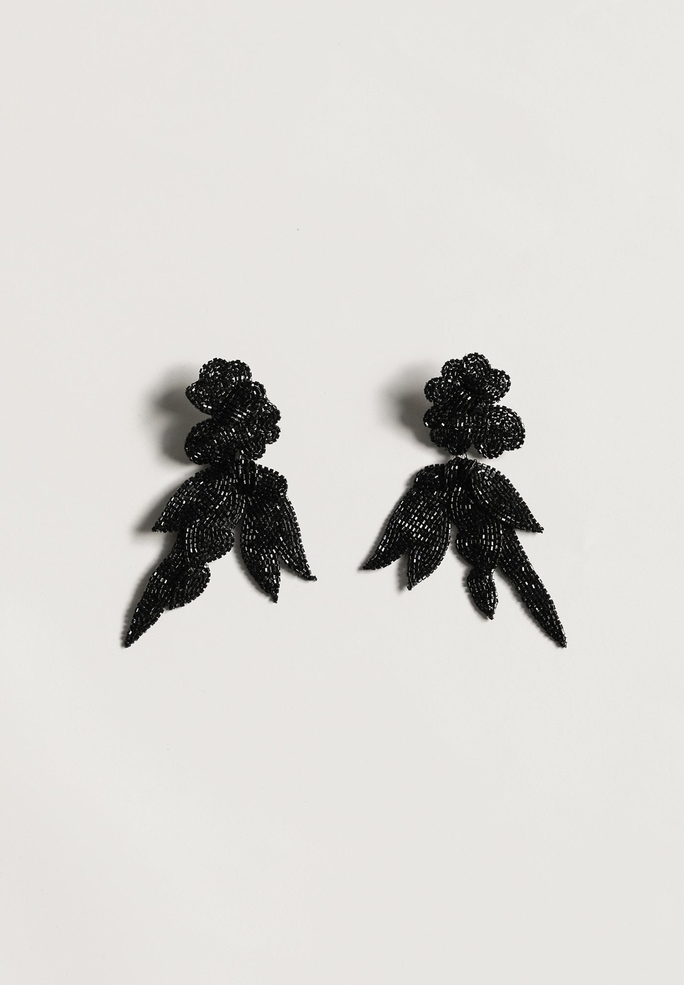 Flat photo of the Maj drop earrings in black by AB Ellie on white background