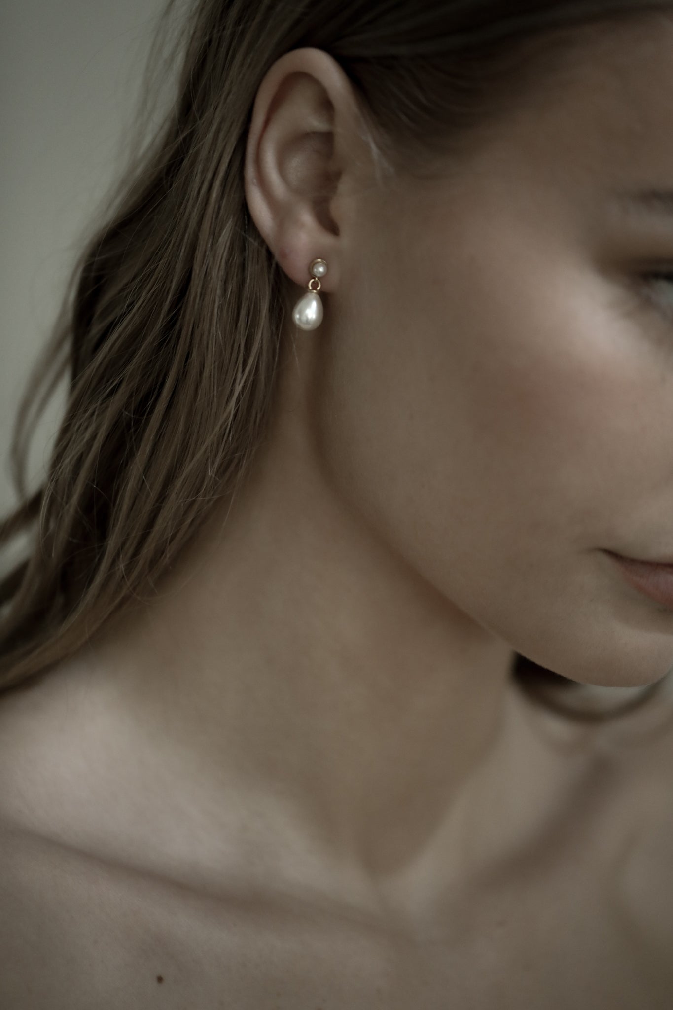 Right side profile of sandy blonde bride wearing the micro pearl drop earrings by AB Ellie Studio Bride collection