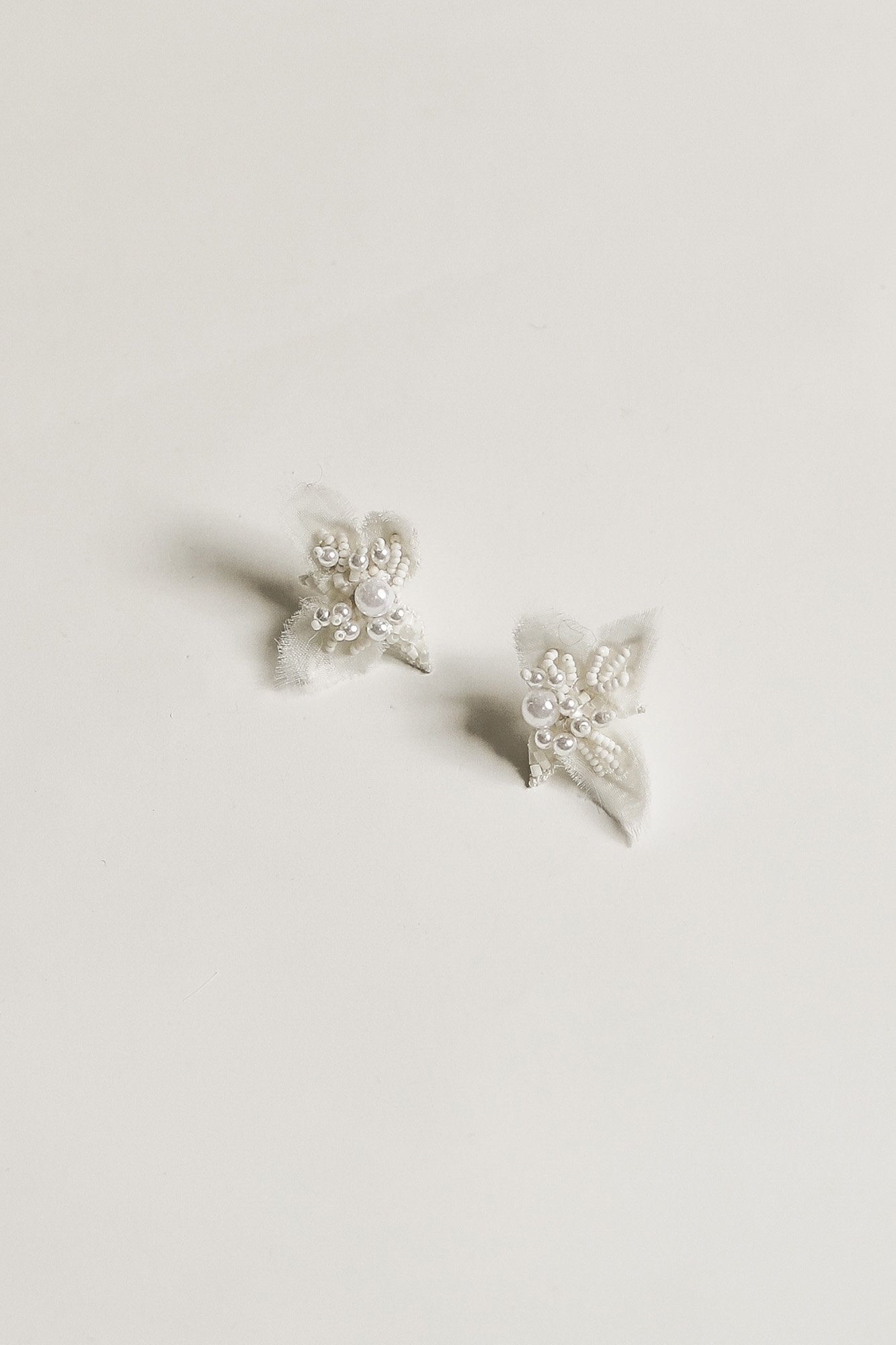 Flat photo of the mini Lexi pearl stud earrings by AB Ellie on white background