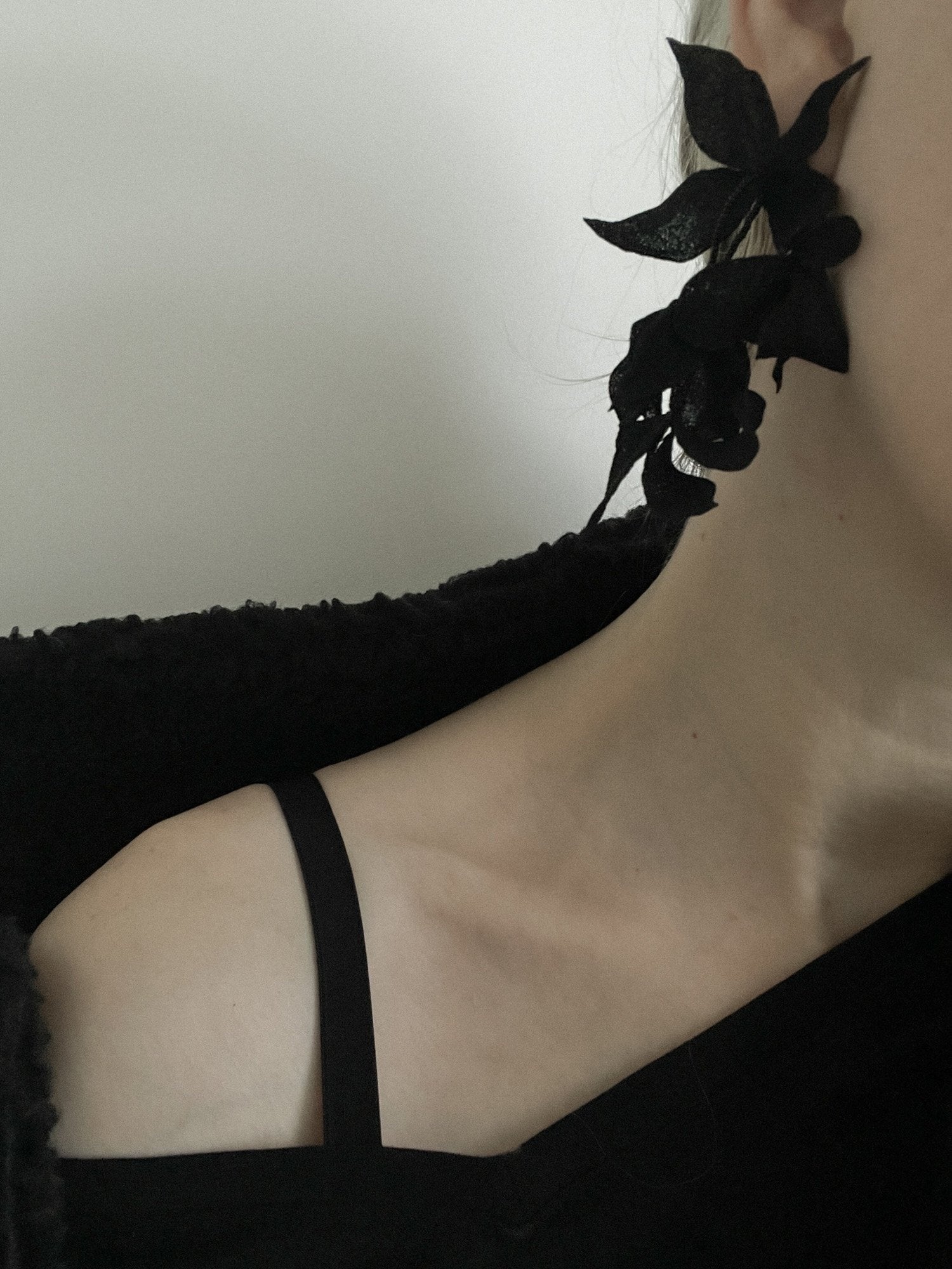 Blonde women wearing the black mini Nora earrings by A.B. Ellie parried with a  black shawl