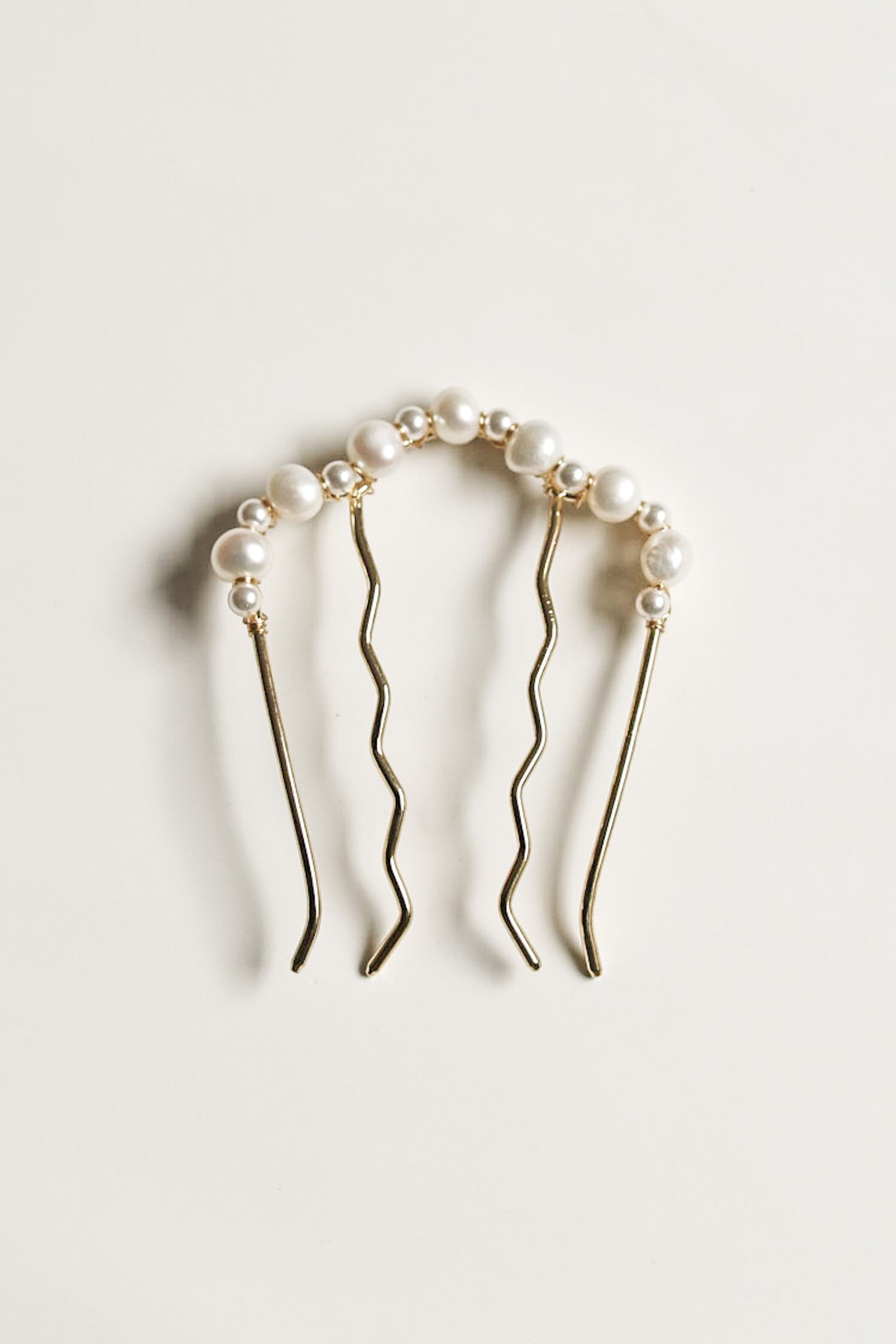 Flat photo of the Paloma freshwater pearl hair comb accessory by AB Ellie on white background