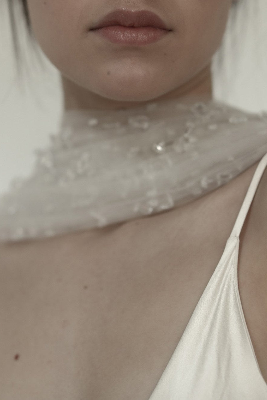 Close up photo of bride wearing the Rain bridal necktie by AB Ellie with sheath dress