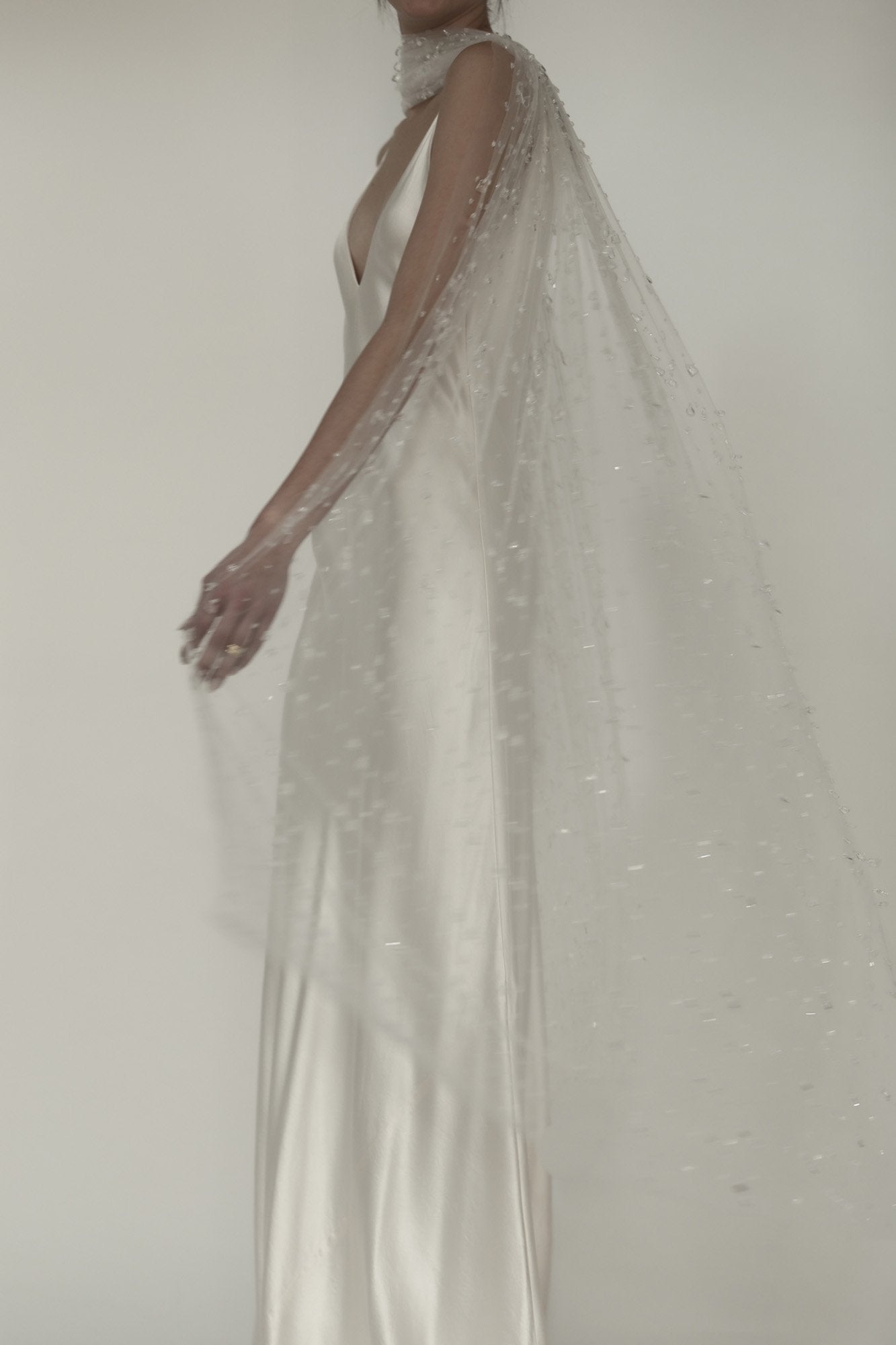 Photo of bride wearing the Rain glass veil and necktie by AB Ellie with sheath dress