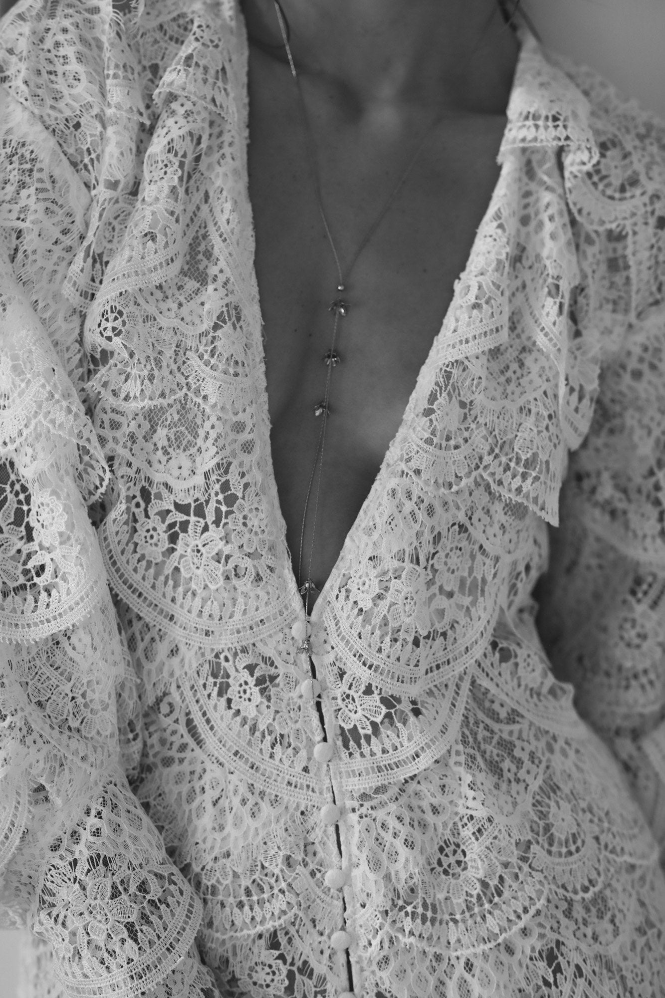 Front view of bride wearing the Rue lariat necklace by AB Ellie paired with a lace dress